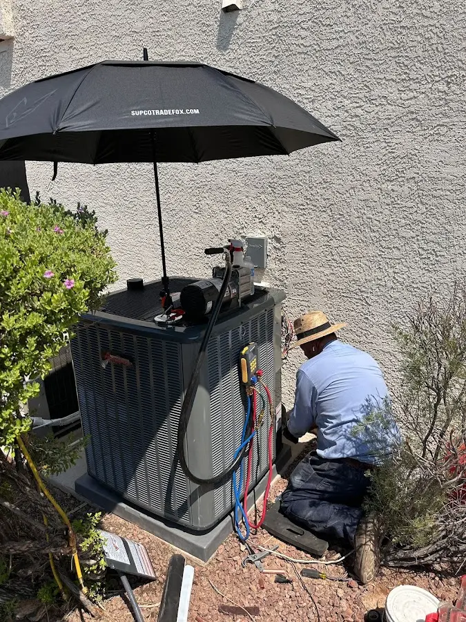 HVAC technician performing outdoor AC maintenance in Bastrop